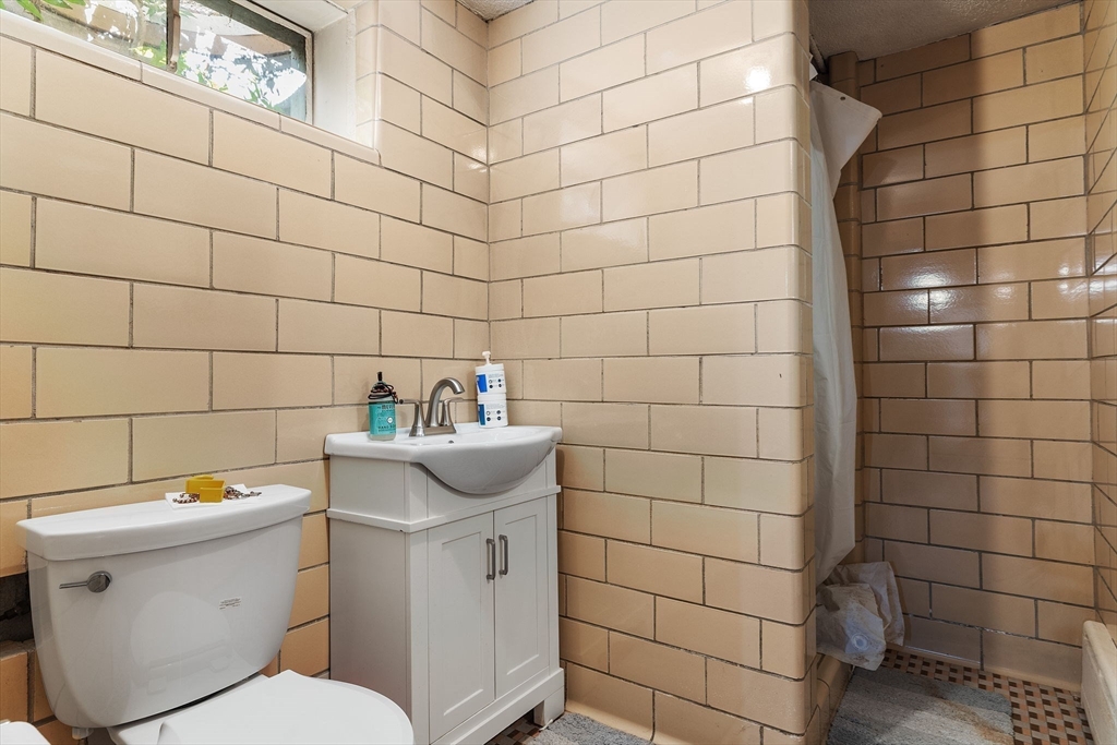 63 Sears Road Milton, MA 02186 - Photo 40 of 42 a bathroom with a sink toilet and shower