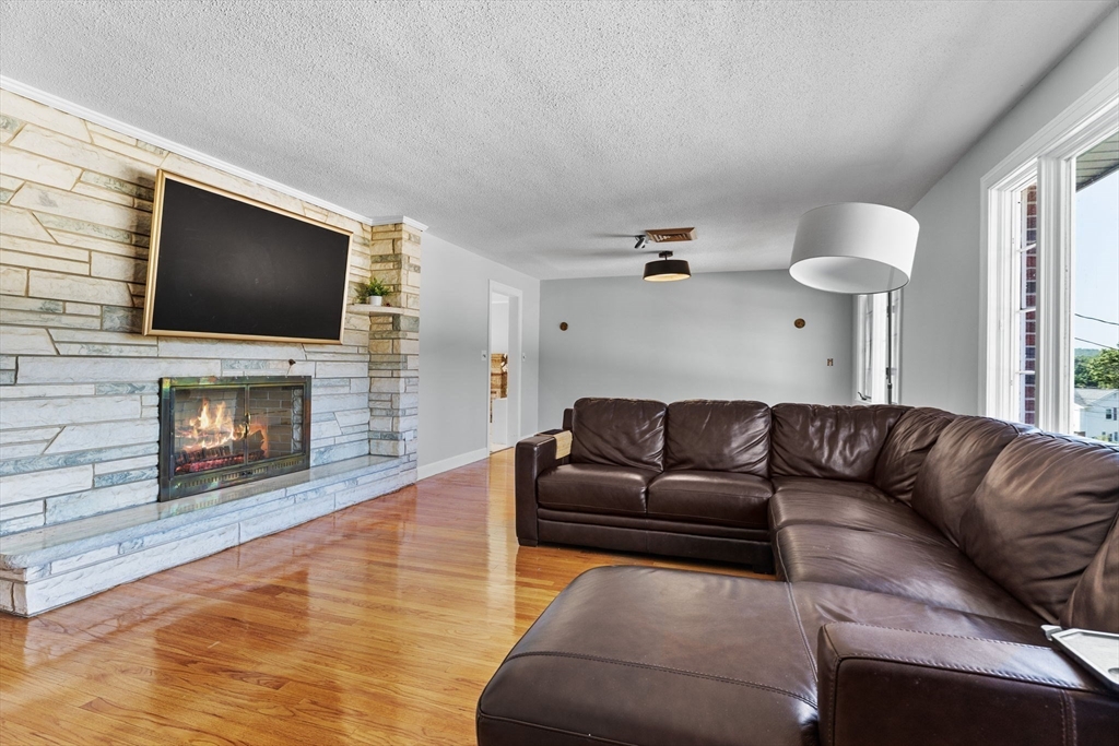 63 Sears Road Milton, MA 02186 - Photo 6 of 42 a living room with fireplace furniture and a flat screen tv