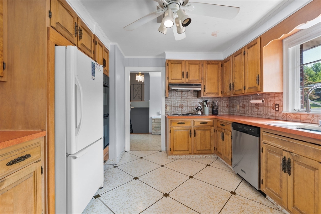 63 Sears Road Milton, MA 02186 - Photo 7 of 42 a kitchen with a refrigerator a sink and cabinets