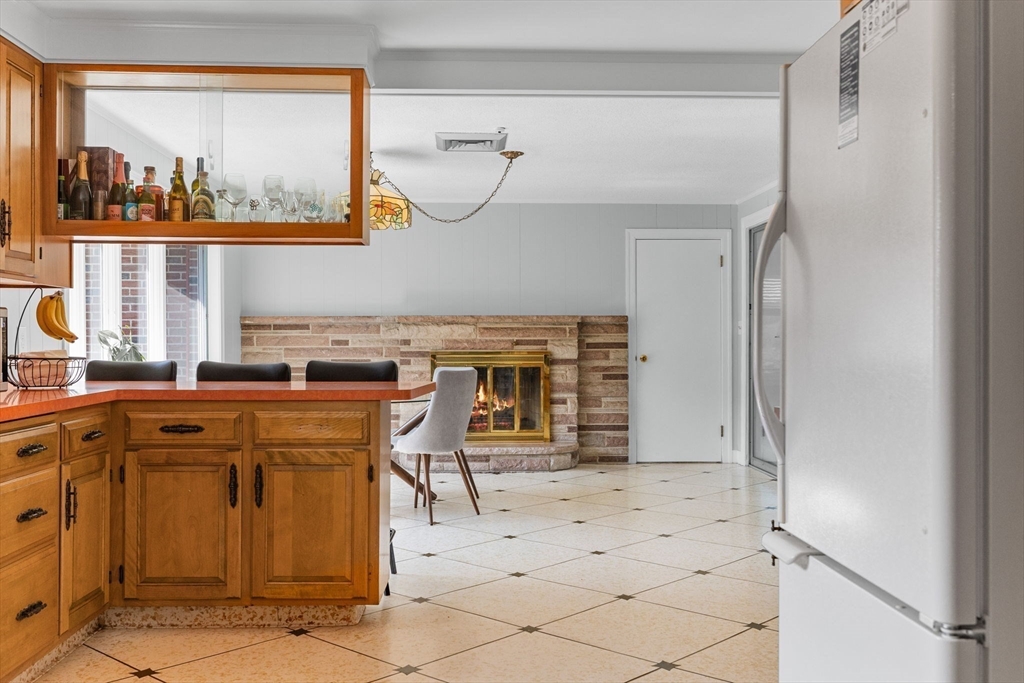 63 Sears Road Milton, MA 02186 - Photo 8 of 42 a kitchen with stainless steel appliances kitchen island granite countertop a refrigerator and a stove top oven