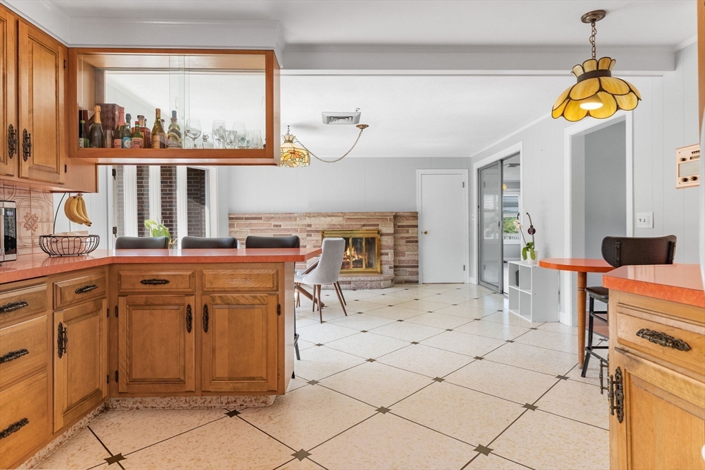 63 Sears Road Milton, MA 02186 - Photo 10 of 42 a kitchen with stainless steel appliances kitchen island granite countertop a stove a sink and a refrigerator