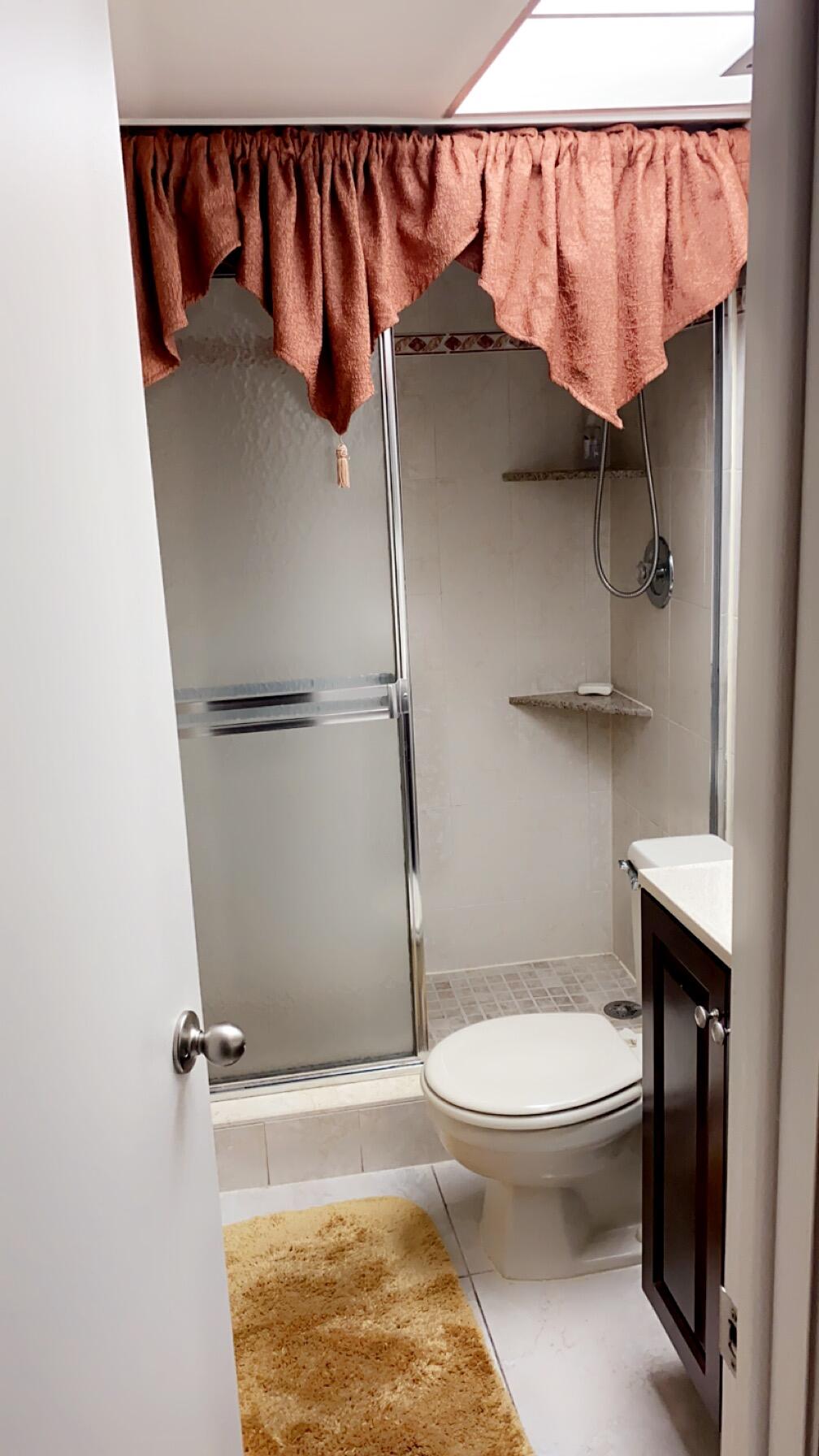 3000 Northwest 48th Terrace, Unit 422 Lauderdale Lakes, FL 33313 - Photo 5 of 9 a bathroom with a toilet and a shower