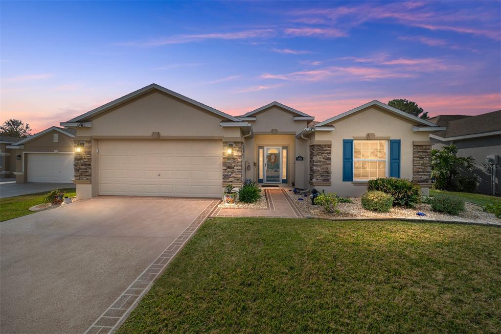 a front view of a house with a yard and garage