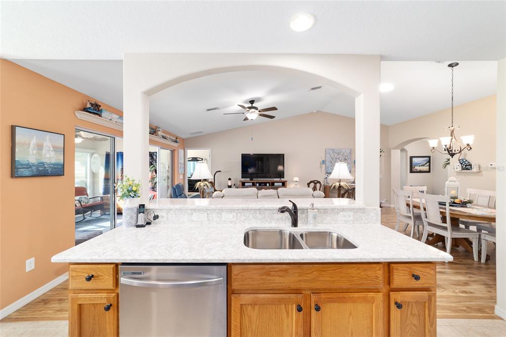 1056 Southwest 159th Street Ocala, FL 34473 - Photo 13 of 45 a view of a kitchen with kitchen island a sink and living room view