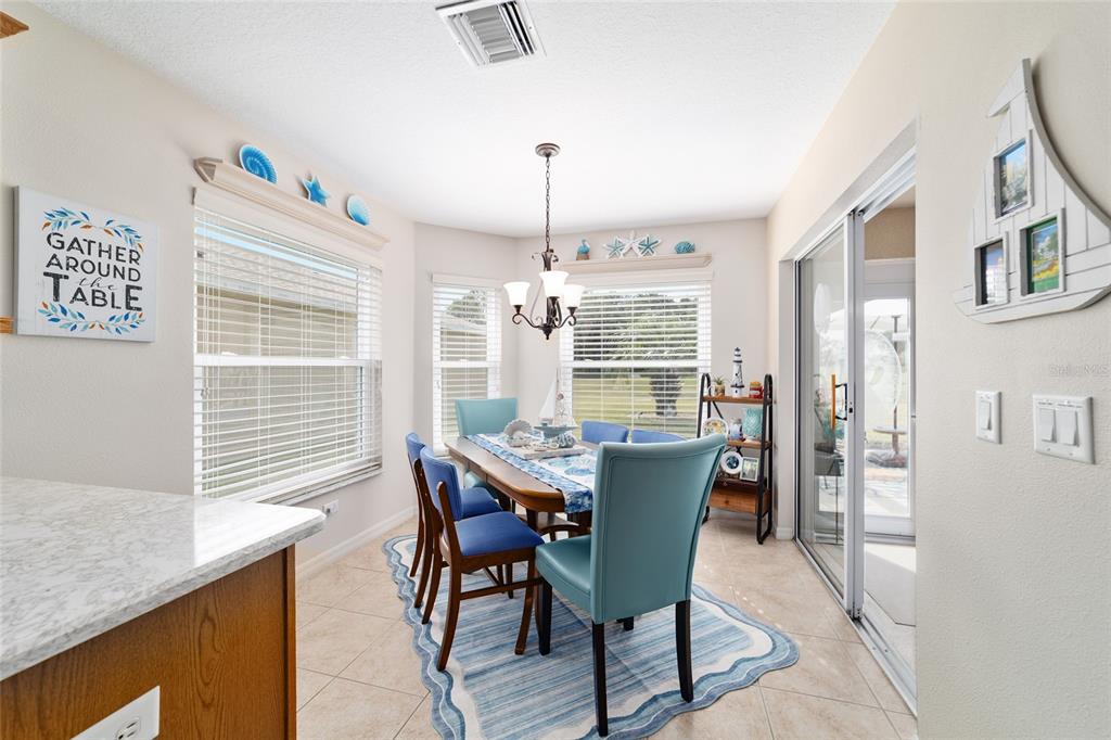 1056 Southwest 159th Street Ocala, FL 34473 - Photo 16 of 45 a dining room with furniture a chandelier and window