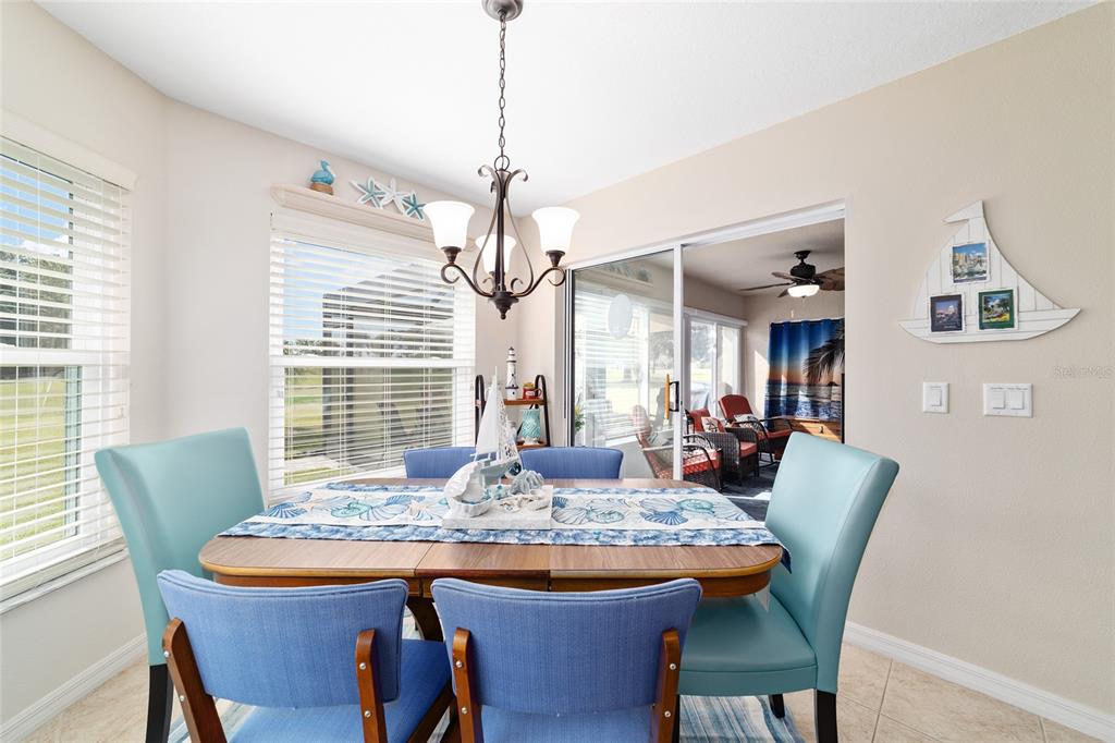 1056 Southwest 159th Street Ocala, FL 34473 - Photo 17 of 45 a view of a dining room with furniture window and wooden floor
