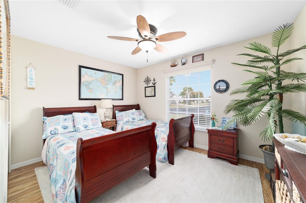 1056 Southwest 159th Street Ocala, FL 34473 - Photo 27 of 45 a bedroom with a bed and a chandelier