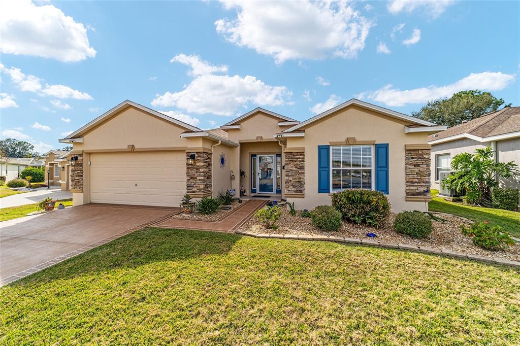 1056 Southwest 159th Street Ocala, FL 34473 - Photo 3 of 45 a front view of a house with garden