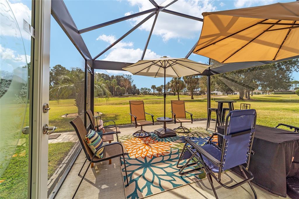 1056 Southwest 159th Street Ocala, FL 34473 - Photo 32 of 45 a view of a patio with a table chairs and a umbrella