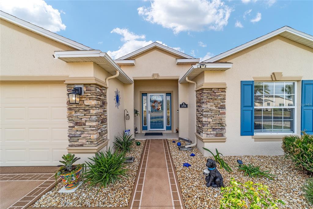 1056 Southwest 159th Street Ocala, FL 34473 - Photo 4 of 45 a front view of a house with a porch