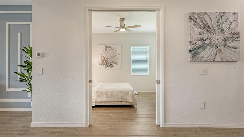 12716 Tulum Loop Venice, FL 34293 - Photo 24 of 97 a bedroom with a bed and a painting on the wall