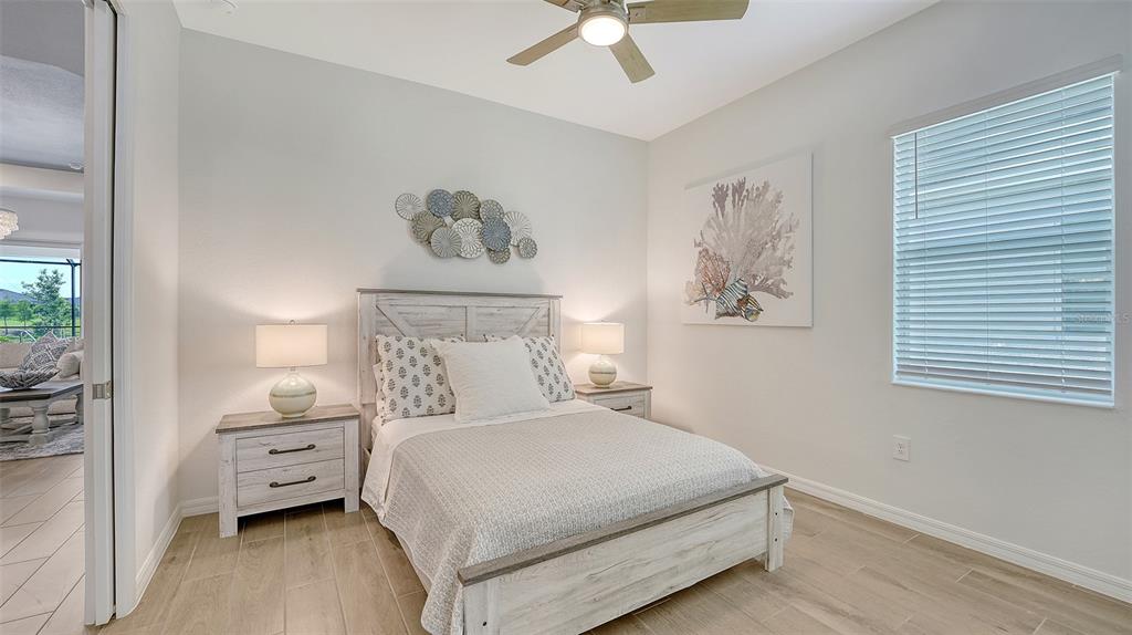 12716 Tulum Loop Venice, FL 34293 - Photo 25 of 97 a bedroom with a bed and a tv