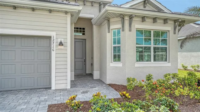 a living room with furniture a flat screen tv and a large window