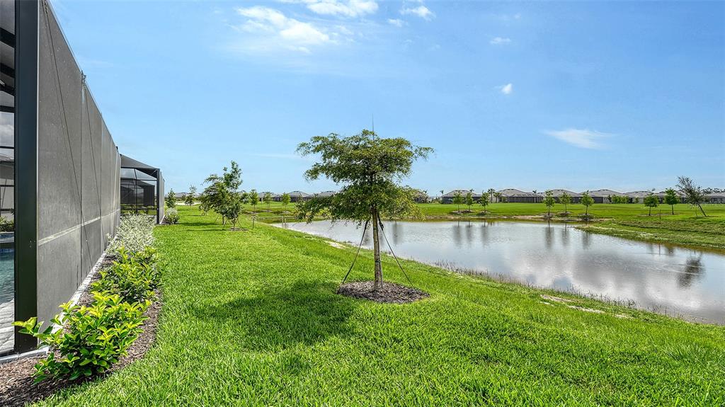 12716 Tulum Loop Venice, FL 34293 - Photo 42 of 97 a view of a lake with a house in the background