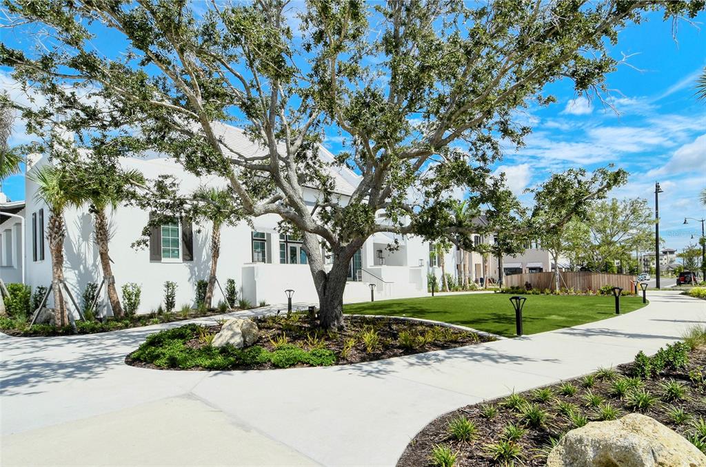 12716 Tulum Loop Venice, FL 34293 - Photo 79 of 97 a front view of a house with a yard and potted plants