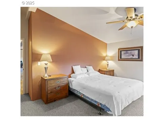 a bedroom with a bed and a painting