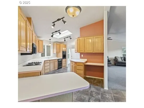 a living room with couches and piano area
