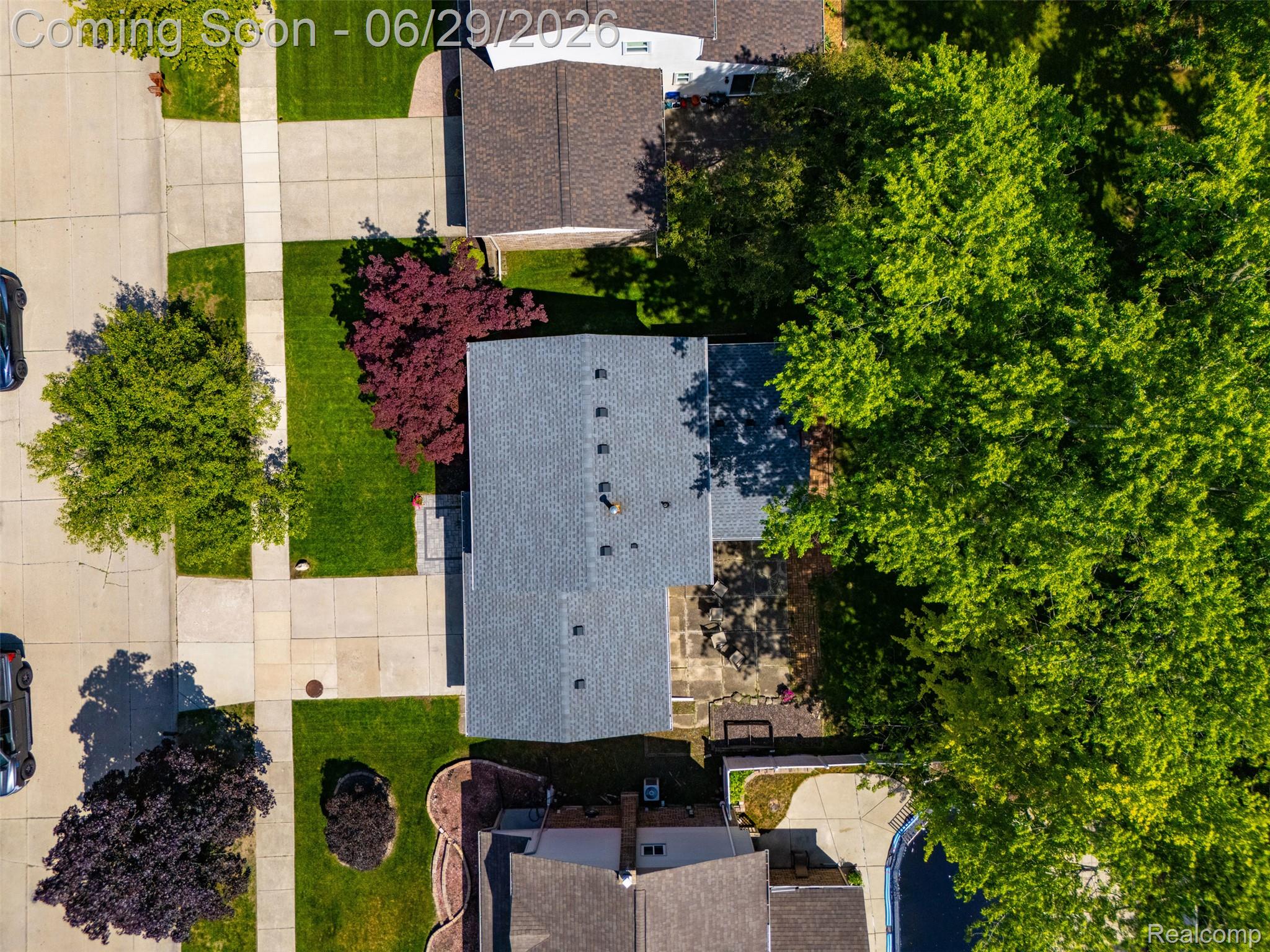 45179 Rudgate Road Canton, MI 48188 - Photo 39 of 48 Residential property with a gray shingle roof and surrounding mature trees