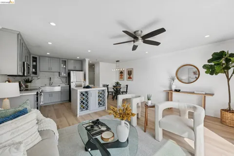 a living room with furniture a kitchen view and a stove