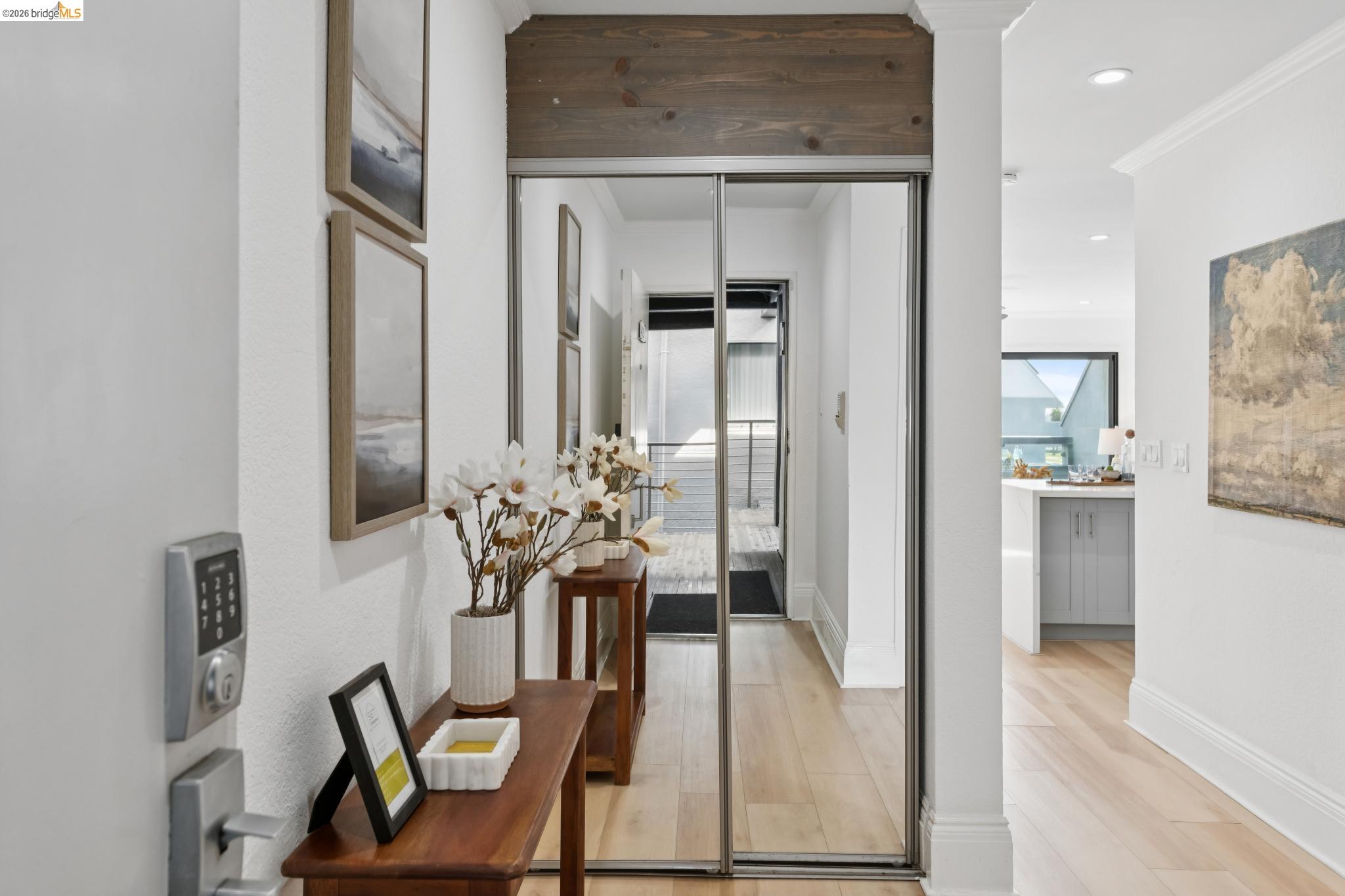 7 Embarcadero, Unit 204 Oakland, CA 94607 - Photo 2 of 27 Hallway with recessed lighting, crown molding, and light wood-style floors