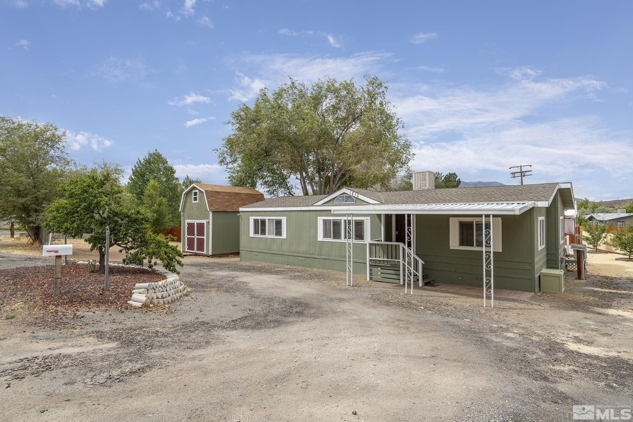 1815 Collins Circle Reno, NV 89506 - Photo 1 of 40 a view of a house with a yard and potted plants