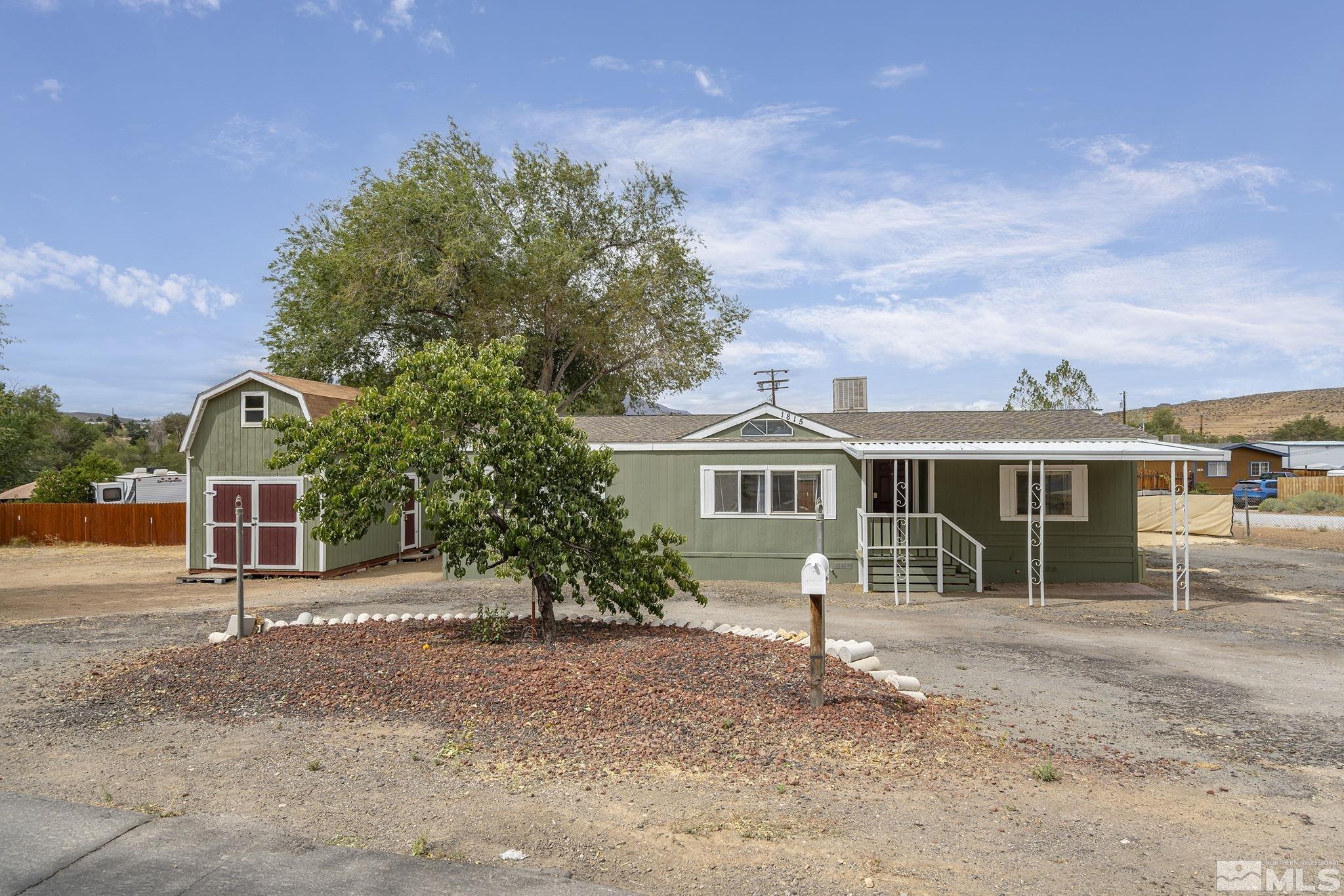1815 Collins Circle Reno, NV 89506 - Photo 2 of 40 a front view of a house with a garden
