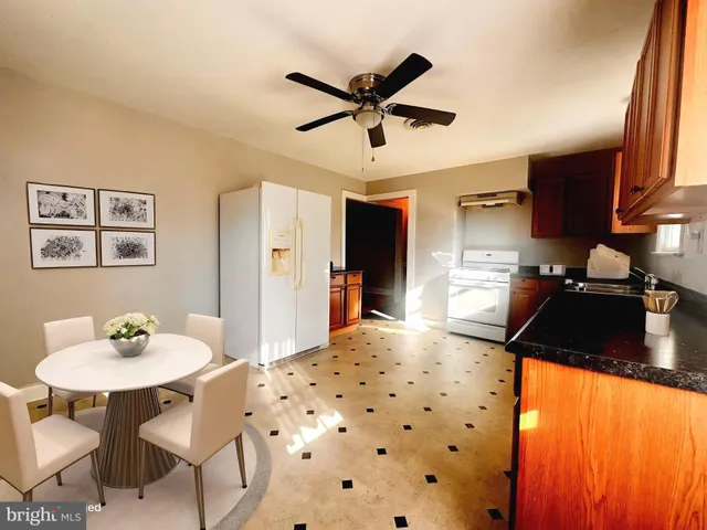 a kitchen with stainless steel appliances kitchen island granite countertop a sink and cabinets