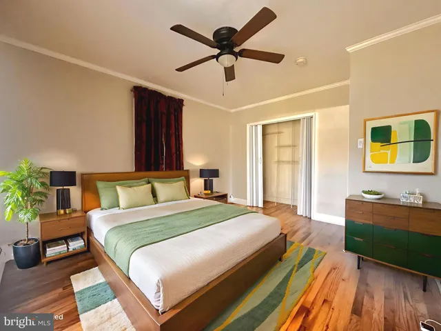 a spacious bedroom with a bed and a dresser