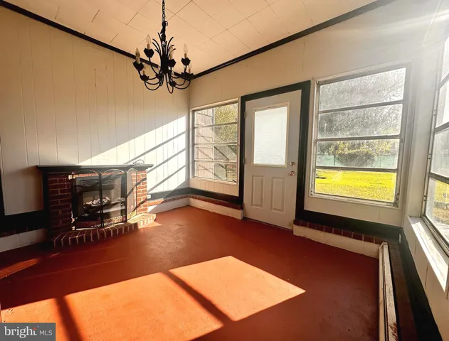 a view of a livingroom with furniture a ceiling fan and window