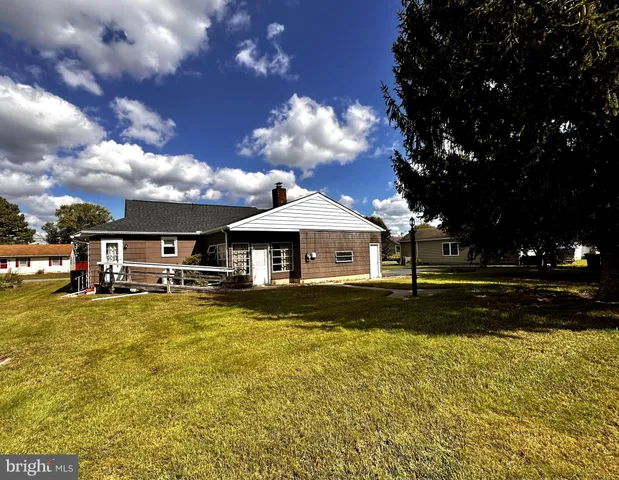 a view of a large house with a big yard