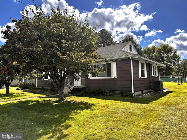 a view of a house with pool and a yard