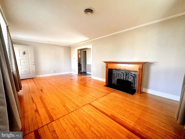 a room with a fireplace and a ceiling fan