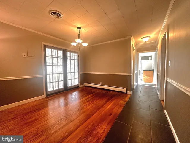 a view of a room with wooden floor