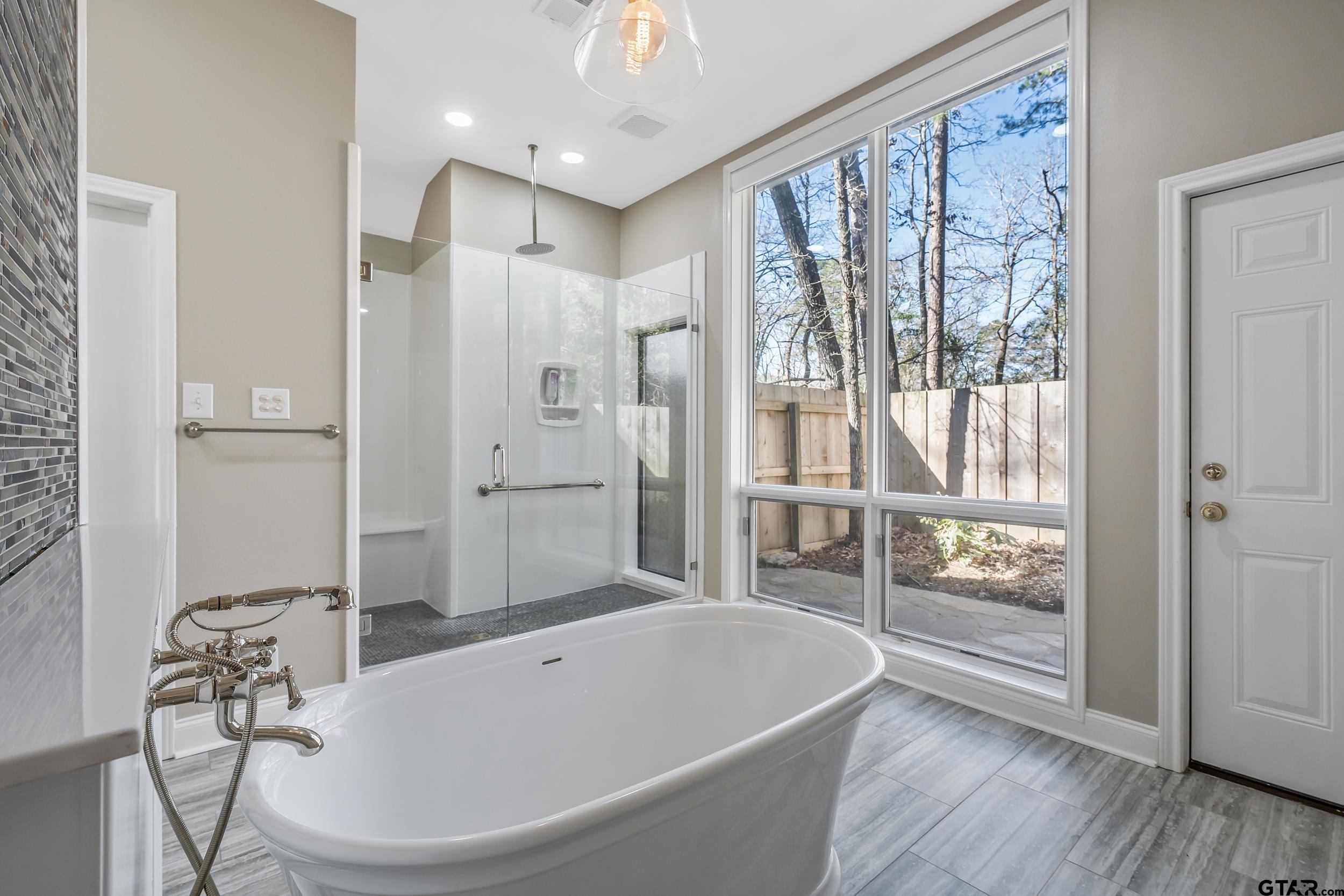 628 Wilder Way Tyler, TX 75703 - Photo 12 of 46 a bathroom with a bathtub and a shower
