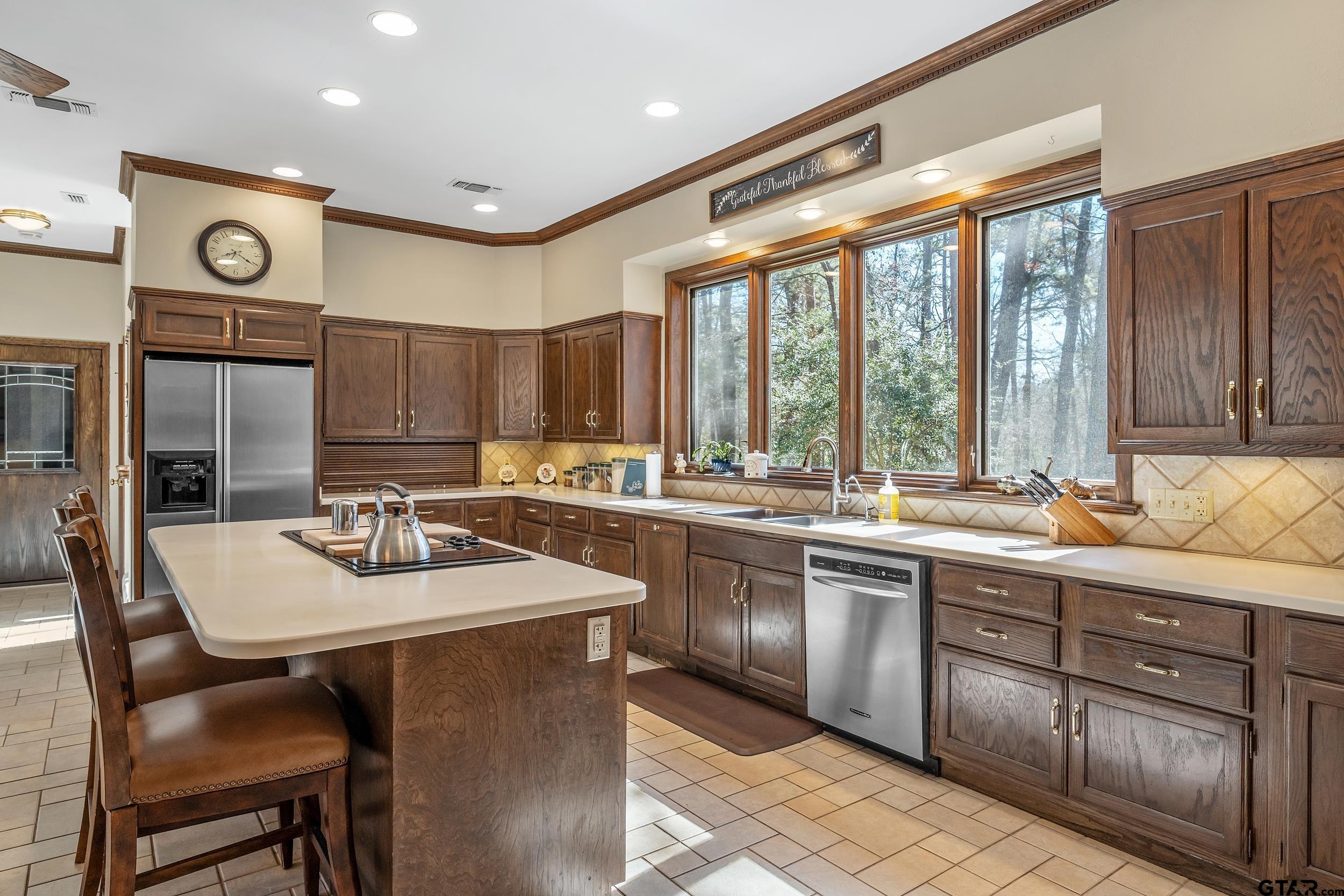 628 Wilder Way Tyler, TX 75703 - Photo 20 of 46 a kitchen with a stove a sink and a refrigerator