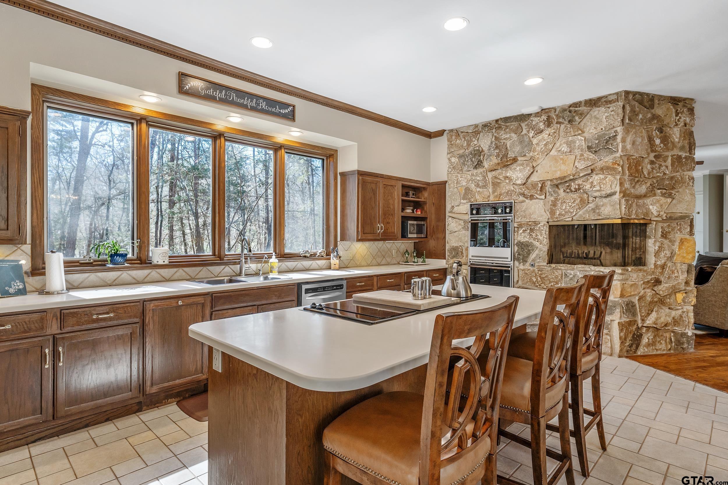 628 Wilder Way Tyler, TX 75703 - Photo 21 of 46 a kitchen with a table chairs sink and cabinets