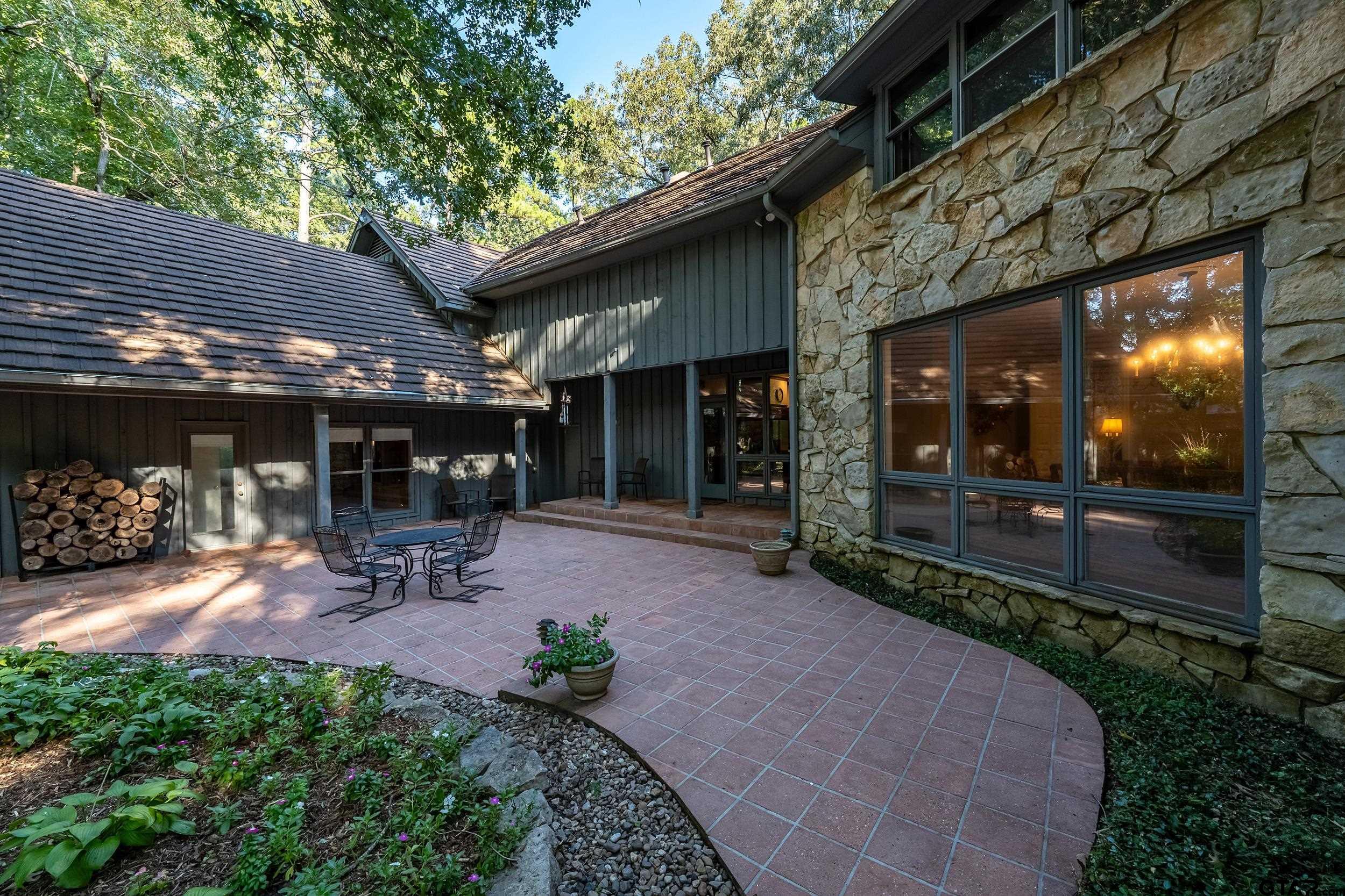 628 Wilder Way Tyler, TX 75703 - Photo 26 of 46 a view of a chairs and table in backyard of the house