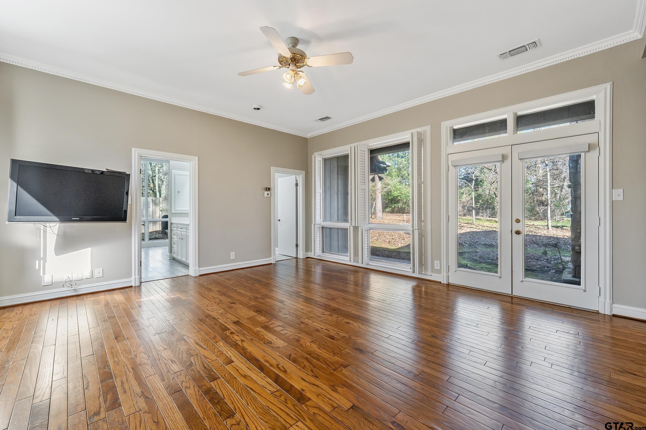 628 Wilder Way Tyler, TX 75703 - Photo 10 of 46 a view of an empty room with wooden floor and a window