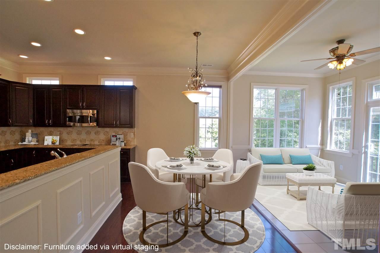 9801 Crooked Tree Lane Raleigh, NC 27617 - Photo 2 of 19 a dining room with furniture a chandelier and window