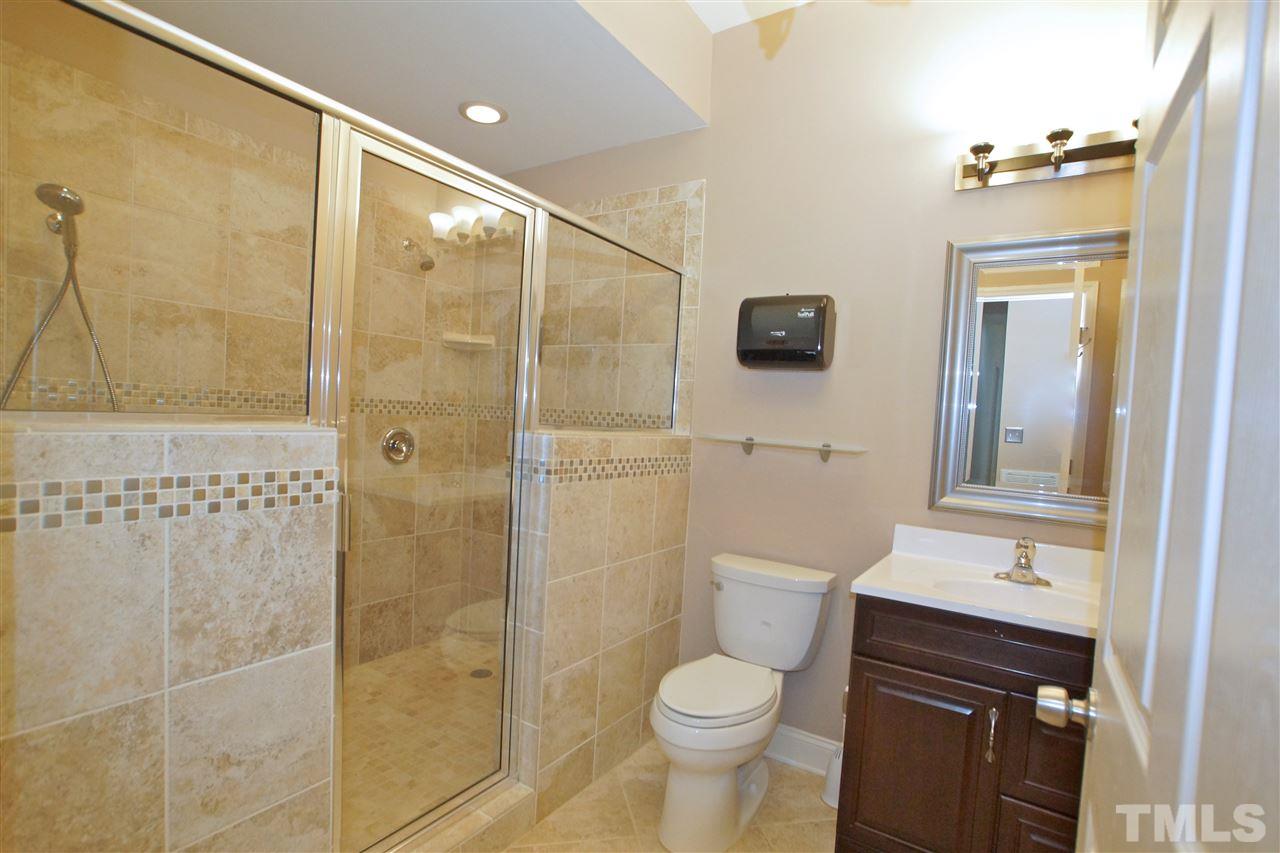 9801 Crooked Tree Lane Raleigh, NC 27617 - Photo 12 of 19 a bathroom with a toilet a sink a shower and mirror