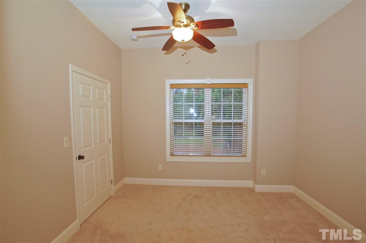 9801 Crooked Tree Lane Raleigh, NC 27617 - Photo 14 of 19 an empty room with a window and a fan