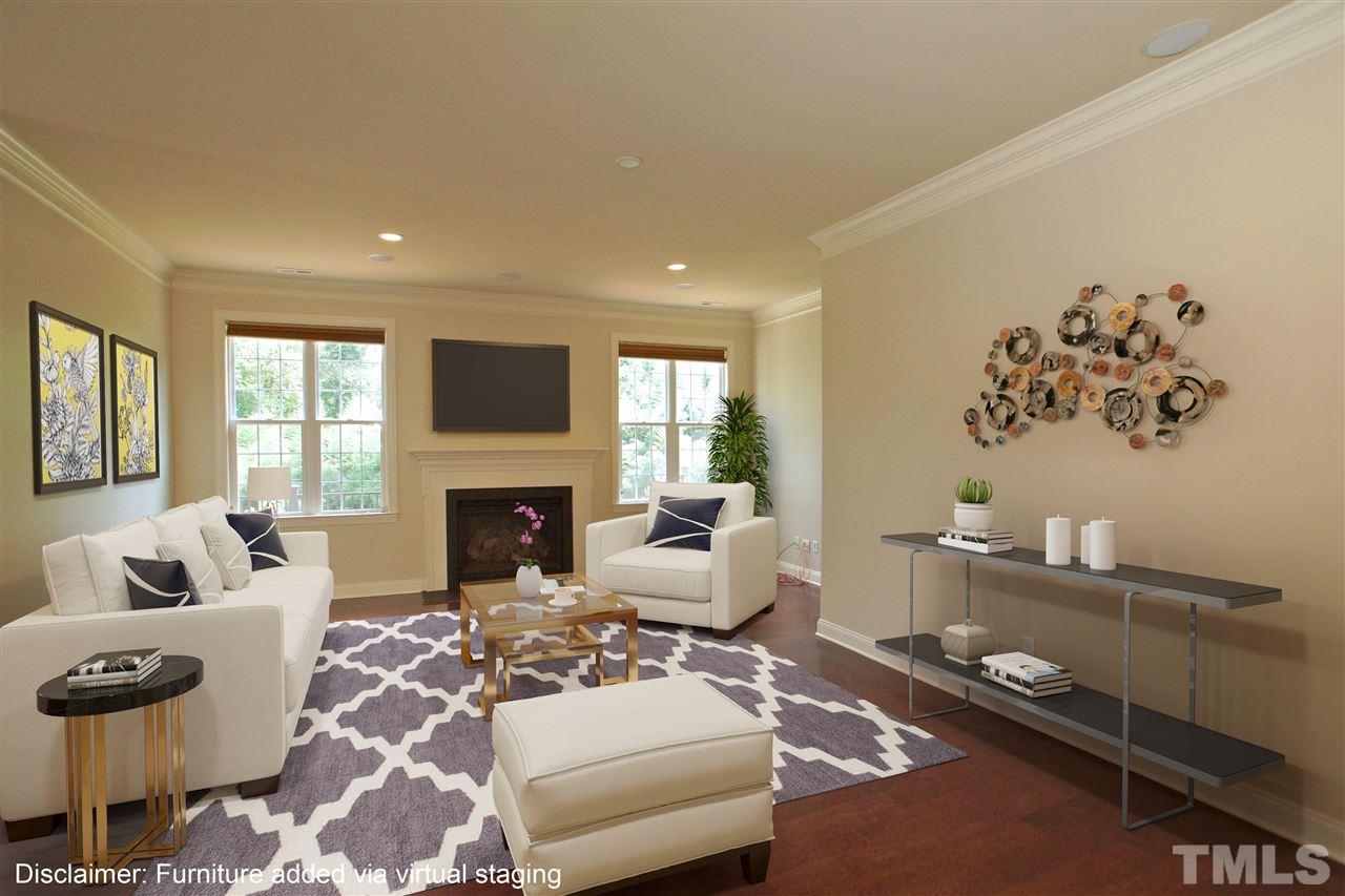 9801 Crooked Tree Lane Raleigh, NC 27617 - Photo 4 of 19 a living room with furniture a fireplace and a flat screen tv
