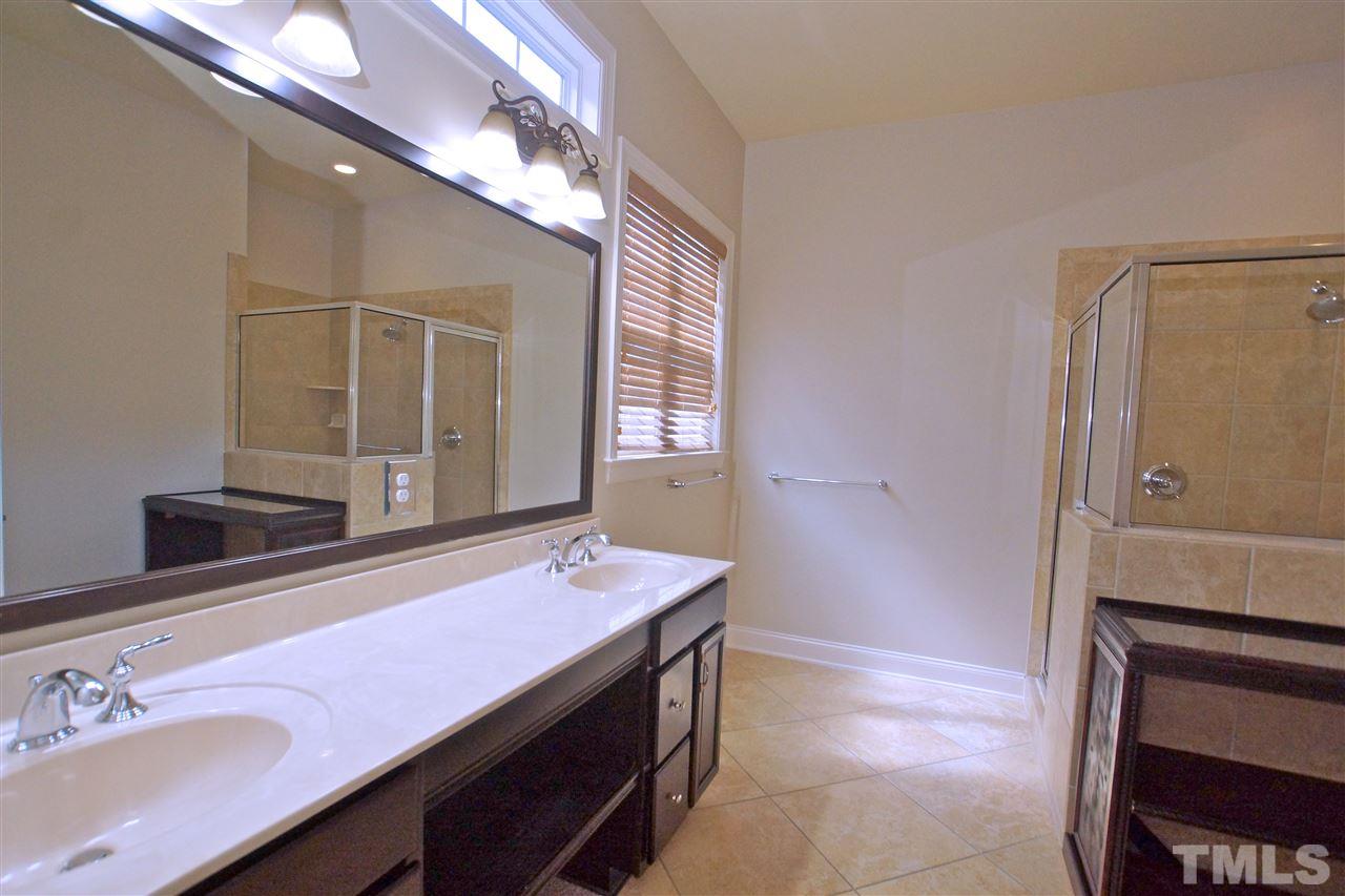9801 Crooked Tree Lane Raleigh, NC 27617 - Photo 8 of 19 a bathroom with a sink a vanity and a mirror