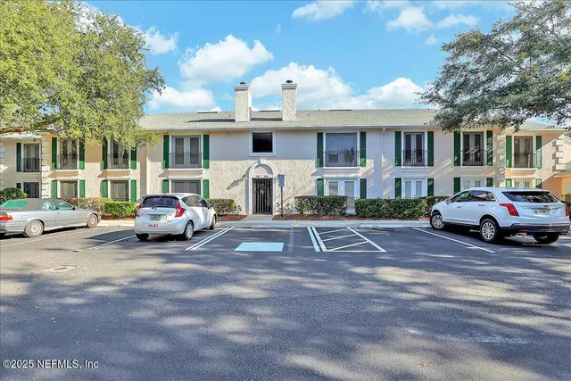 a view of a cars park in front of a building