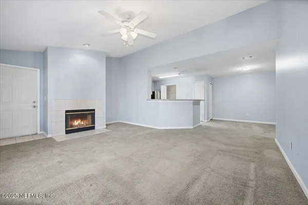 a view of a kitchen with a sink and a fireplace