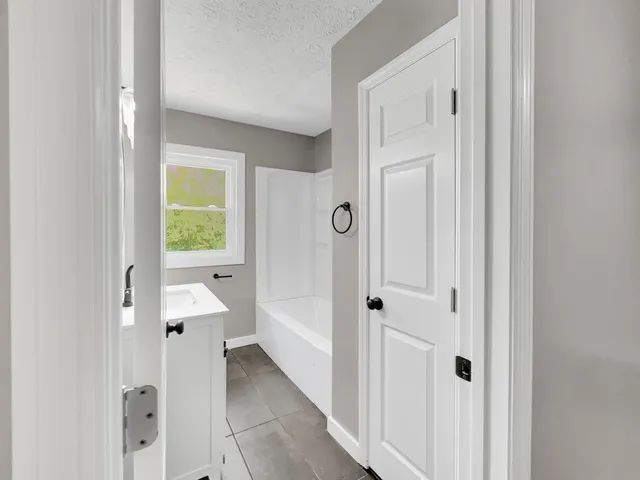 a view of a bathroom with a toilet sink and mirror