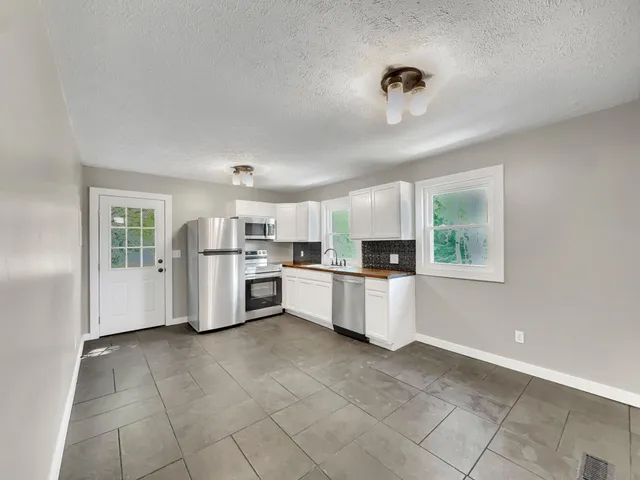 a kitchen with a refrigerator and a sink