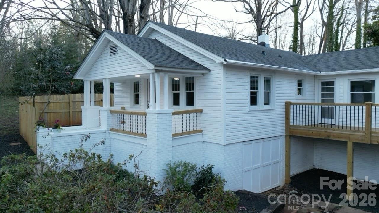 50 Hidden Hill Road Tryon, NC 28782 - Photo 1 of 29 a view of a house with wooden deck and furniture