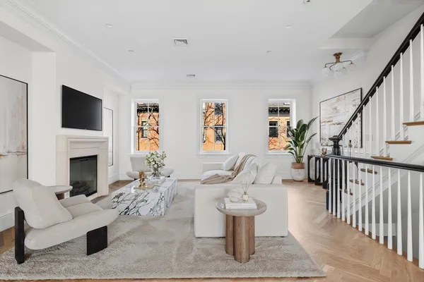 a living room with furniture a fireplace and a flat screen tv