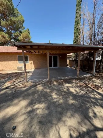 a backyard of a house with table and chairs